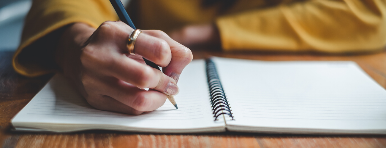 person writing in a notebook